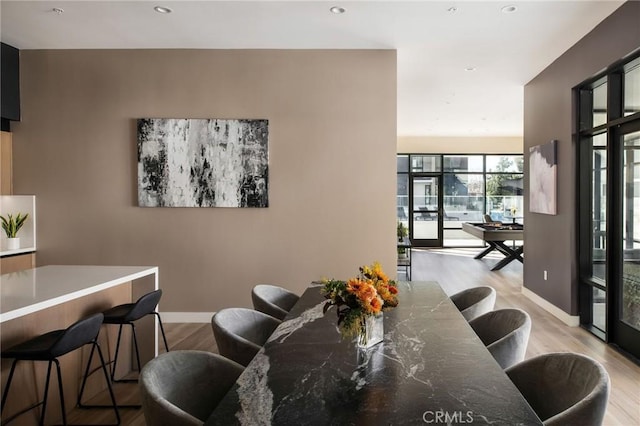 dining area with light hardwood / wood-style floors