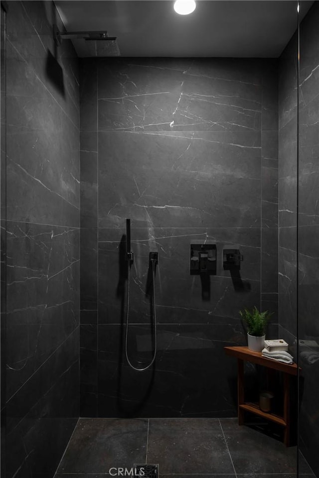 bathroom with a tile shower