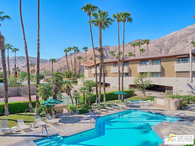 view of pool featuring a mountain view and a patio area