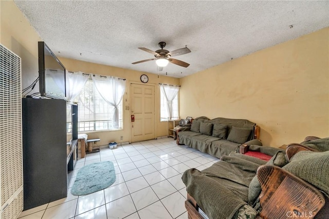 tiled living room with ceiling fan and a textured ceiling