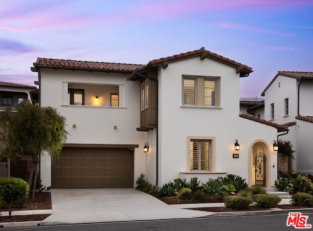 mediterranean / spanish home featuring a garage