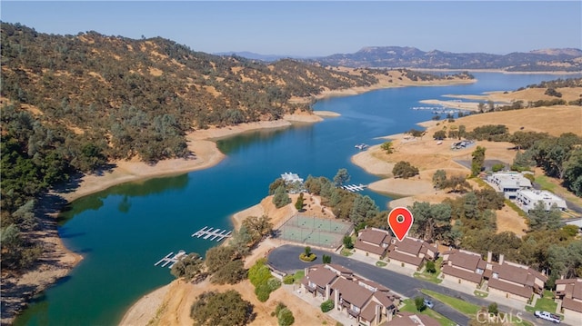 drone / aerial view featuring a water and mountain view