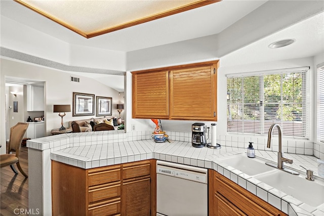 kitchen with tile counters, dishwasher, kitchen peninsula, and dark wood-type flooring