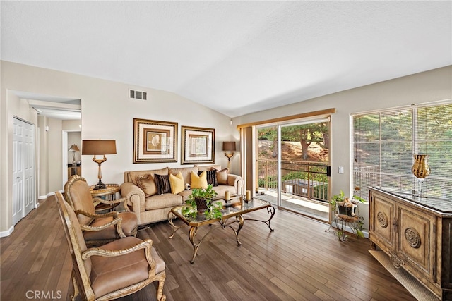 living room featuring vaulted ceiling, hardwood / wood-style flooring, baseboards, and visible vents