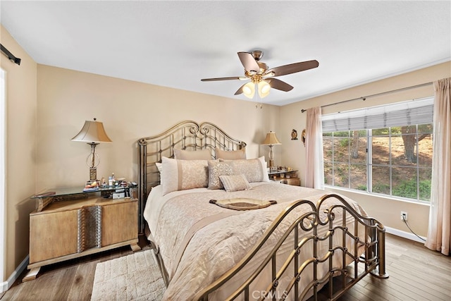 bedroom featuring hardwood / wood-style floors and ceiling fan