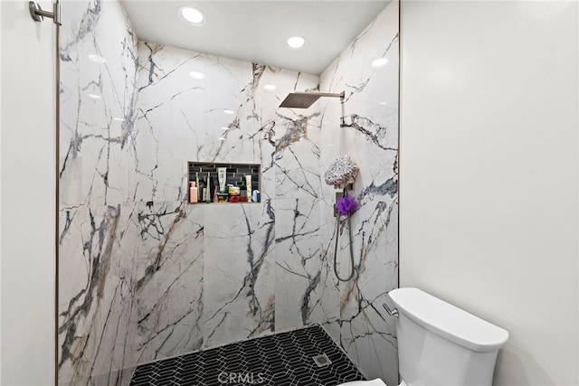 bathroom with tiled shower and toilet