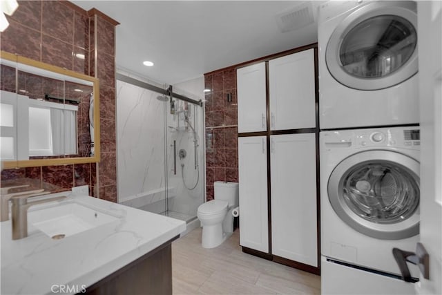 4140 Baldwin Ave Unit A, Culver City, CA 90232 - bathroom featuring stacked washer and clothes dryer, tile walls, a marble finish shower, vanity, and recessed lighting