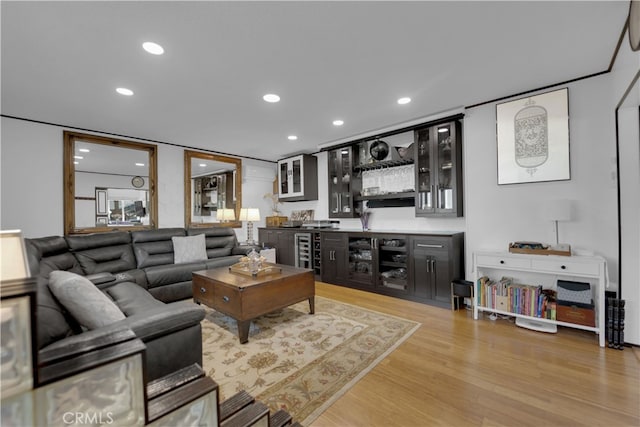 living room featuring bar and light hardwood / wood-style floors