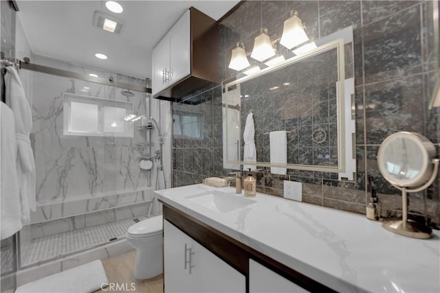 4140 Baldwin Ave Unit A, Culver City, CA 90232 - bathroom featuring a marble finish shower, vanity, tile walls, and recessed lighting