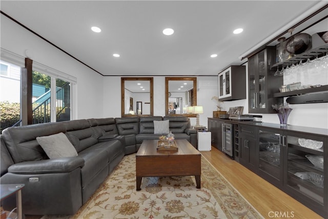 living room with beverage cooler and light hardwood / wood-style floors