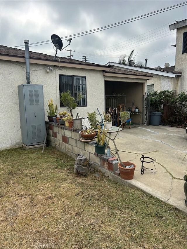 rear view of property with a patio area and a yard