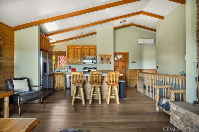 30008 Hickory Dr, Lake Arrowhead, CA 92321 - kitchen featuring appliances with stainless steel finishes, vaulted ceiling, light countertops, a wall mounted air conditioner, and a center island