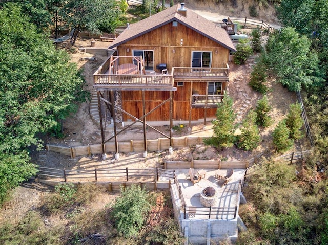 rear view of house with a deck and a patio