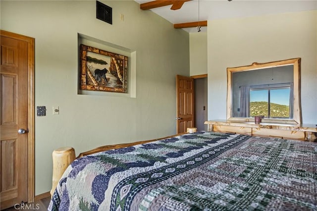 bedroom with ceiling fan and lofted ceiling with beams