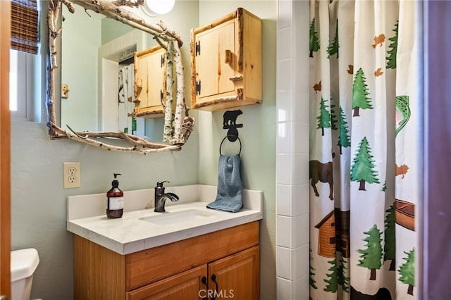 bathroom with vanity, curtained shower, and toilet