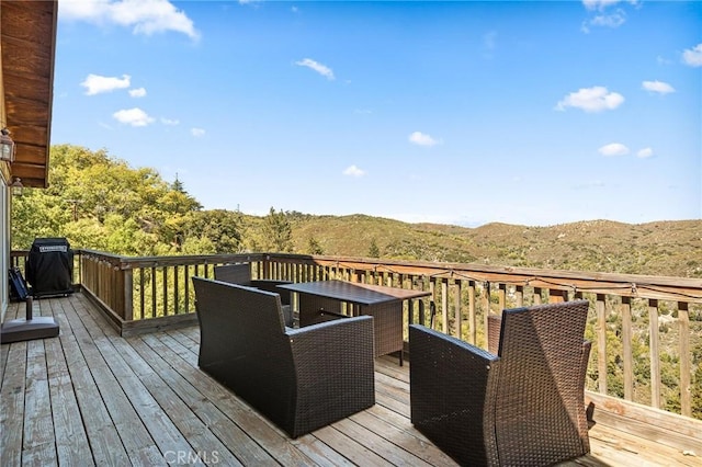 deck with a mountain view and a grill