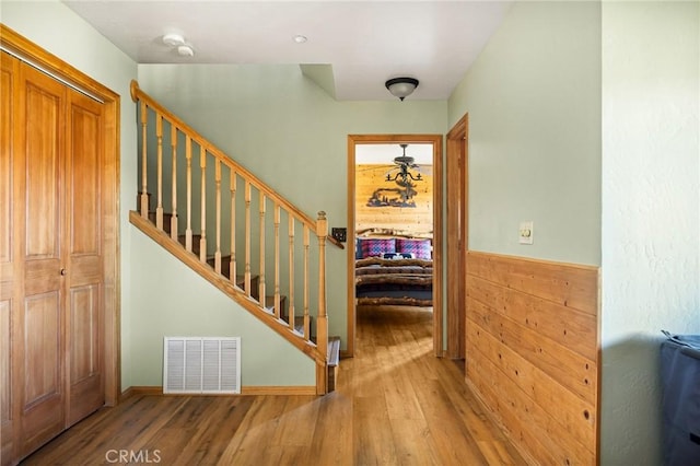 staircase with hardwood / wood-style flooring