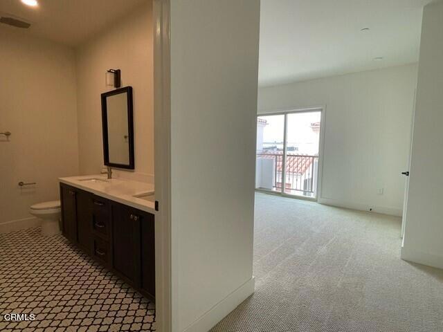 bathroom featuring vanity and toilet