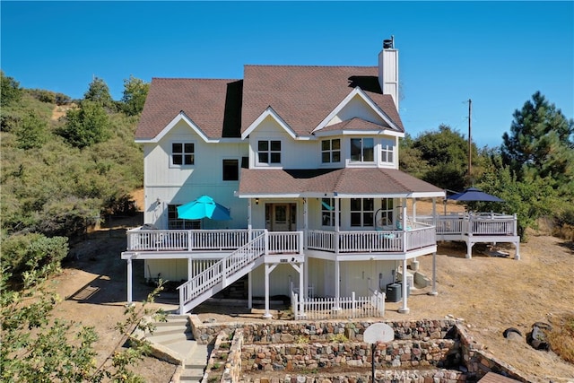 back of house featuring a wooden deck