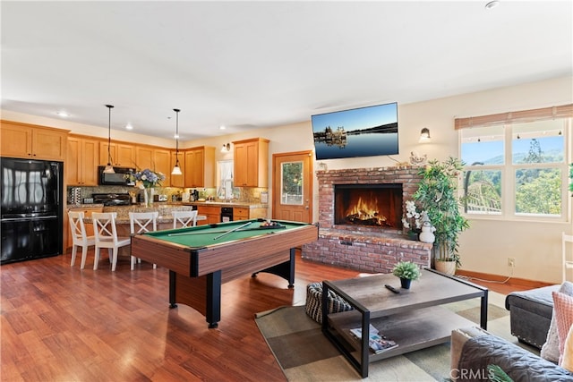 playroom with pool table, hardwood / wood-style floors, and a fireplace