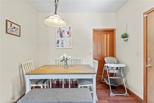 dining space featuring dark hardwood / wood-style flooring