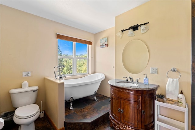 bathroom featuring a bathtub, vanity, and toilet