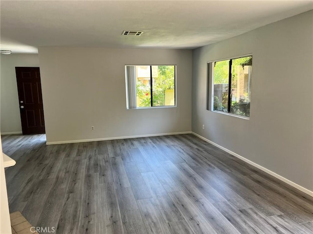 spare room with dark wood-type flooring