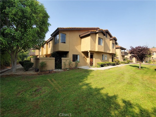 rear view of property with a lawn