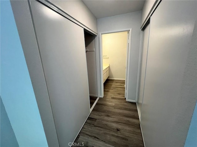 corridor with dark wood-type flooring