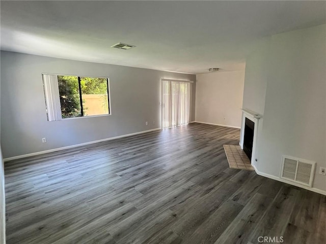 unfurnished living room featuring dark wood-type flooring