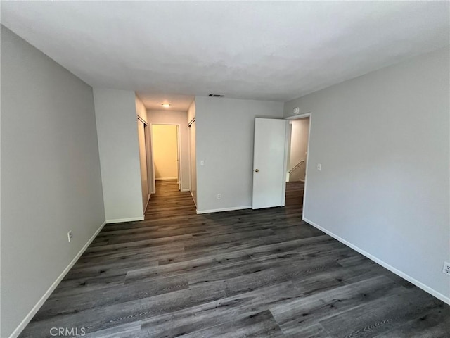 spare room with dark hardwood / wood-style floors