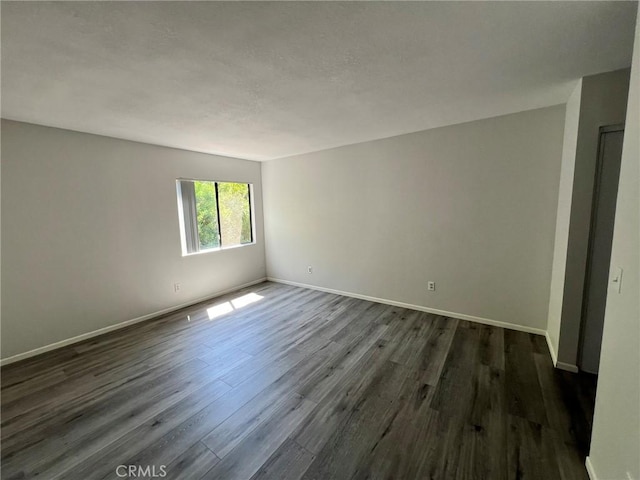 empty room featuring dark hardwood / wood-style flooring