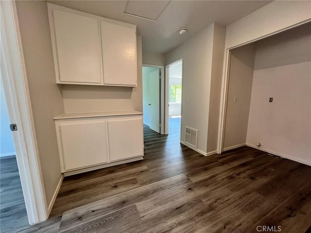 unfurnished dining area featuring dark hardwood / wood-style floors