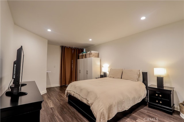 bedroom with dark hardwood / wood-style floors