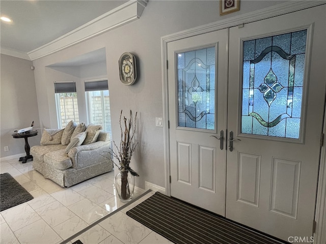 entryway featuring french doors and crown molding