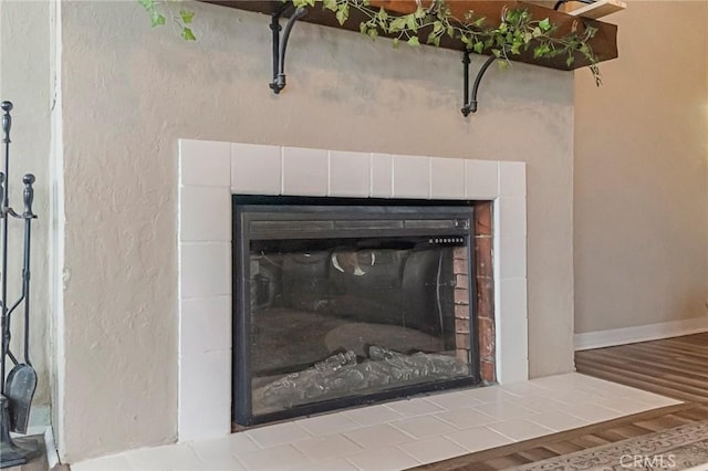 interior details featuring a fireplace and hardwood / wood-style floors