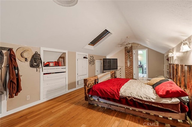 bedroom with wood-type flooring and lofted ceiling