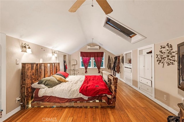 bedroom with ceiling fan, wood-type flooring, and lofted ceiling