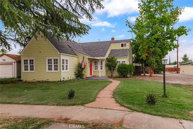 view of front of home with a front yard and a garage