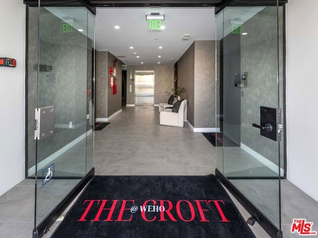 bathroom featuring elevator and concrete flooring