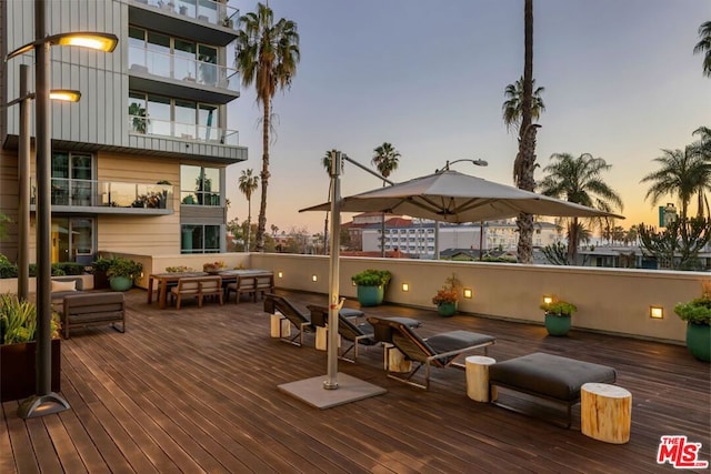 deck at dusk with an outdoor hangout area