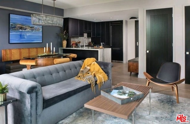 living room featuring light wood-type flooring and sink