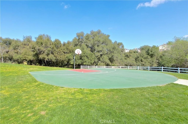 view of basketball court featuring a yard