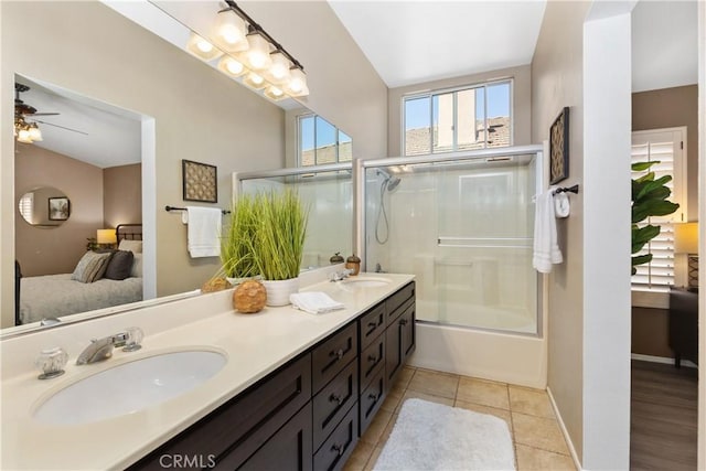 bathroom featuring ceiling fan, tile patterned flooring, vanity, and bath / shower combo with glass door