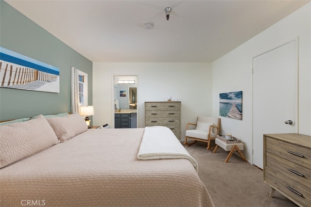 bedroom featuring light carpet and connected bathroom