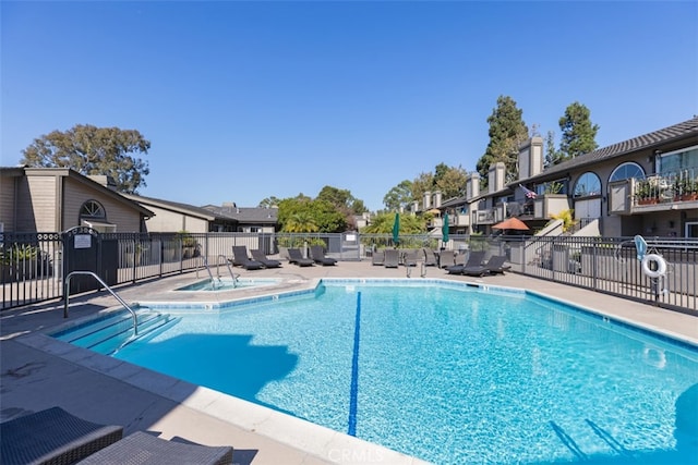 view of swimming pool featuring a community hot tub