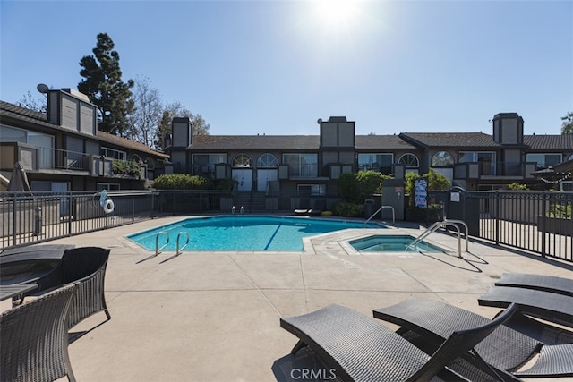 view of pool featuring a hot tub and a patio