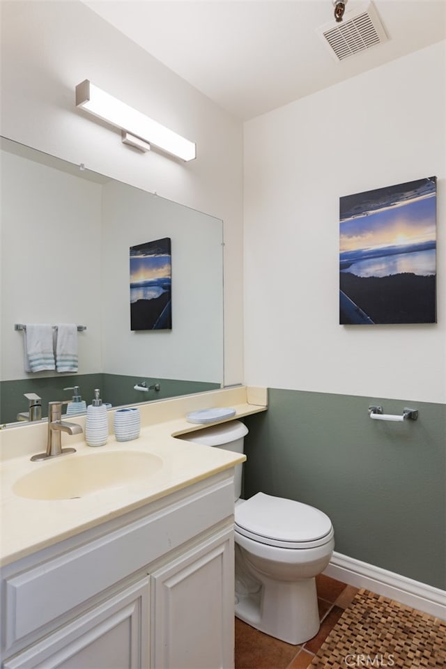 bathroom featuring tile patterned flooring, vanity, and toilet