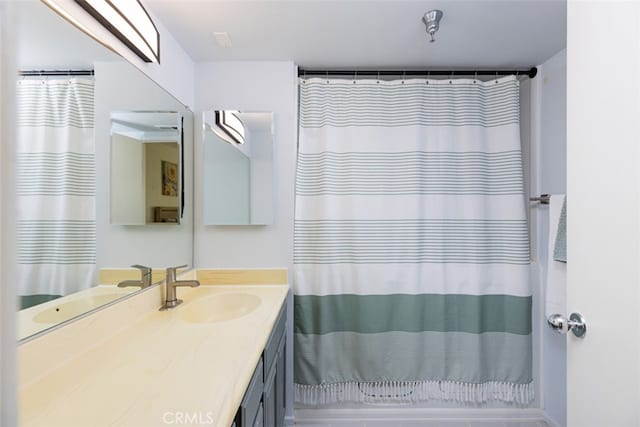 bathroom featuring vanity and a shower with shower curtain