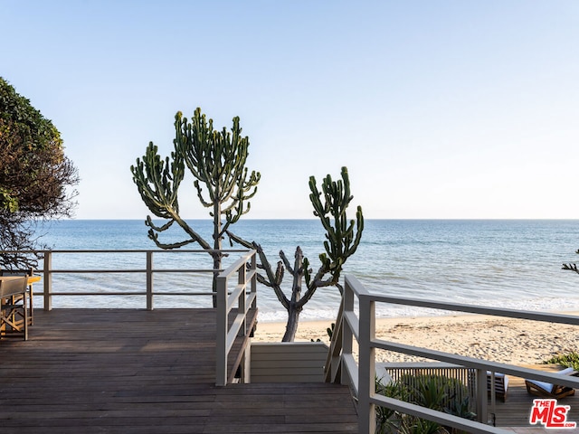 exterior space with a water view and a beach view